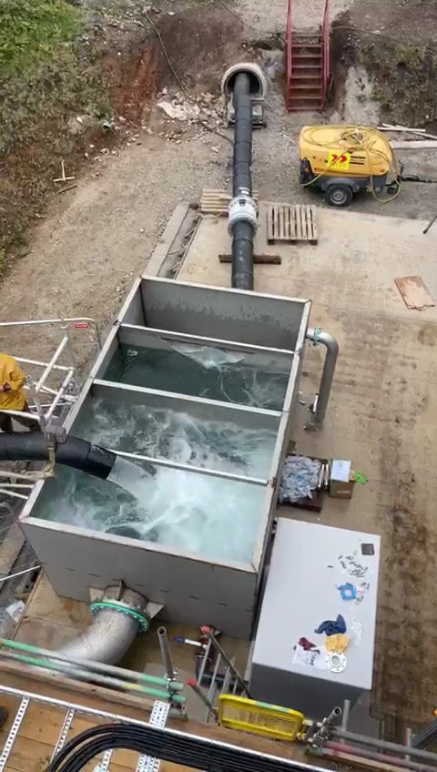 Water being pumped through the water discharge tank and being re-circulated into the old mine workings during pump commissioning