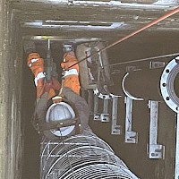 Installation of escape ladder and discharge pipes into Middle Engine Shaft